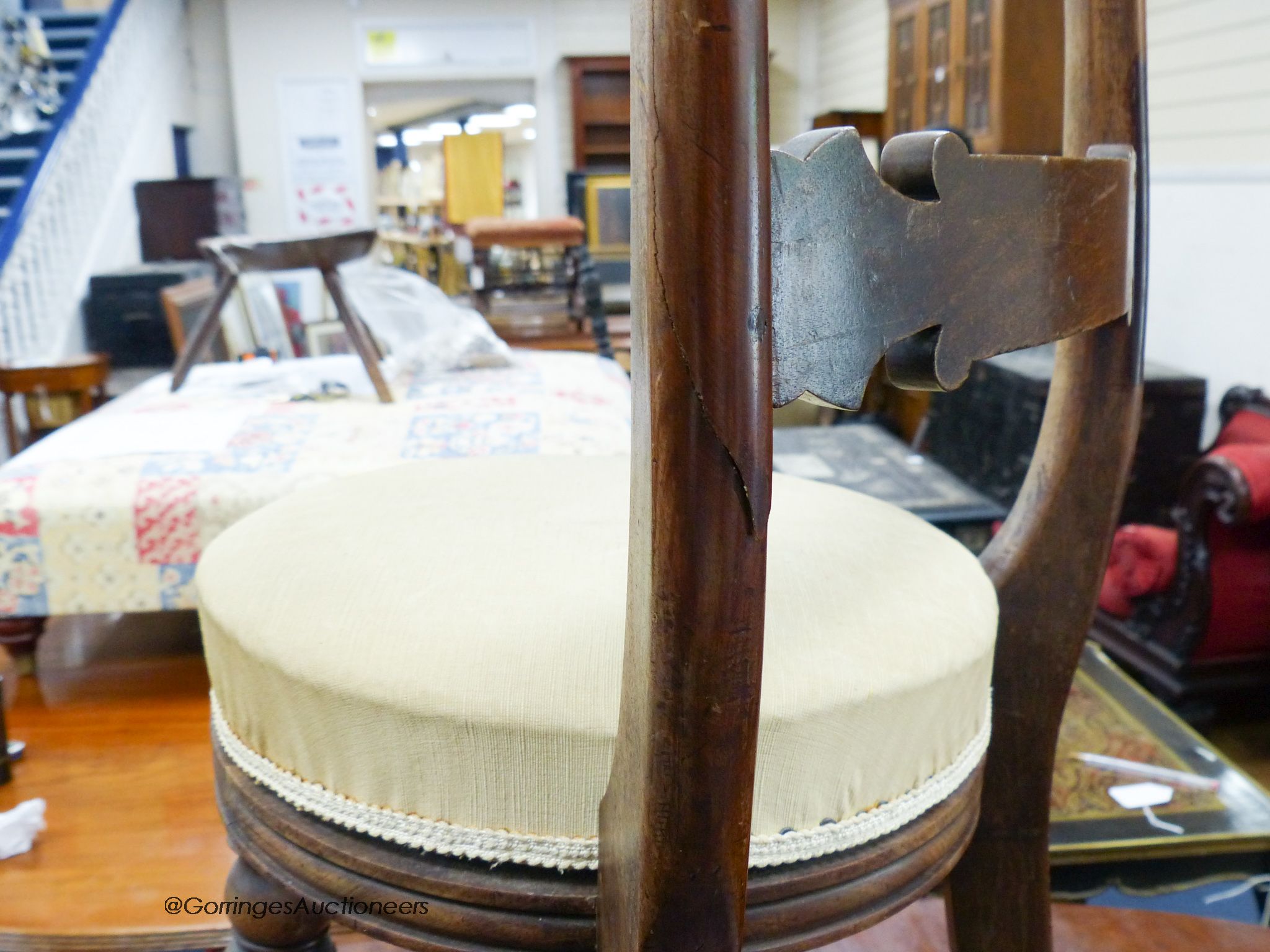 A regency brass inlaid mahogany music stool.